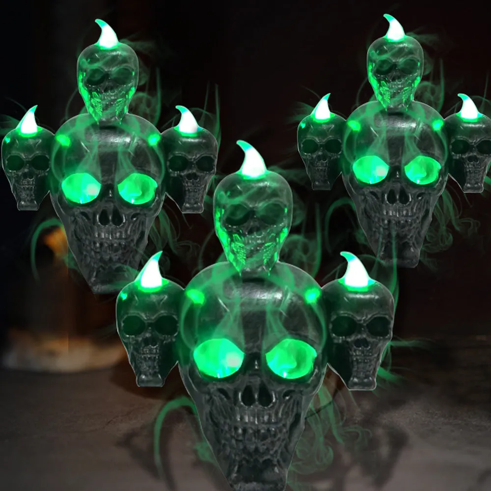 Halloween skull ornament with LED light, gold and silver, plastic, 14x12x9cm, on dark background