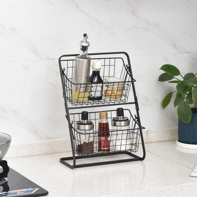 Two-tier black stainless steel kitchen storage rack with fruit and vegetables on a countertop