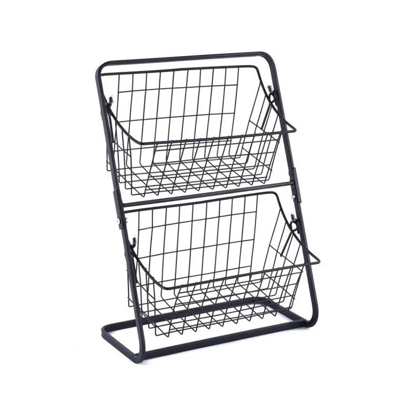 Two-tier black stainless steel kitchen storage rack with fruit and vegetables on a countertop