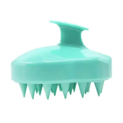 Silicone scalp massage brush with soft bristles in green colour on white background