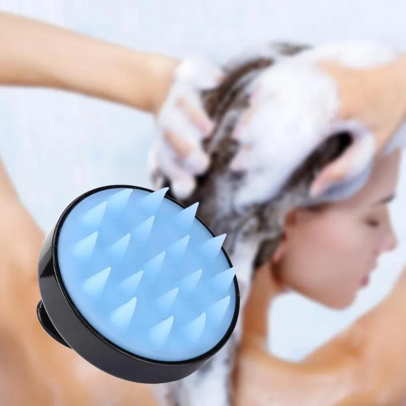 Silicone scalp massage brush with soft bristles in green colour on white background