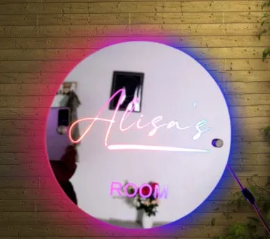 Personalised acrylic name mirror light with LED glow on wall in picture colour