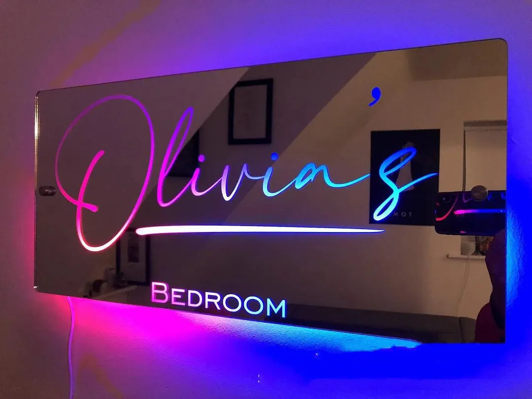 Personalised acrylic name mirror light with LED glow on wall in picture colour