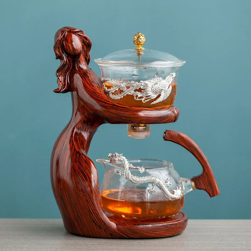 Maid semi-automatic glass tea set with heat-resistant borosilicate glass teapot, stainless steel filters, and Chinese style frame on a tea tray