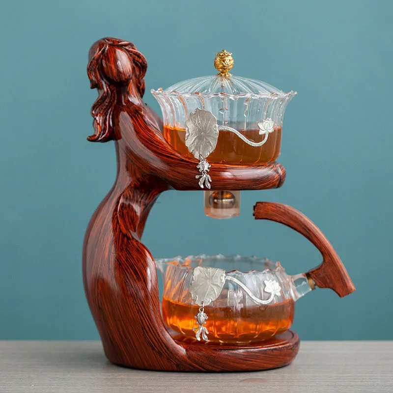 Maid semi-automatic glass tea set with heat-resistant borosilicate glass teapot, stainless steel filters, and Chinese style frame on a tea tray