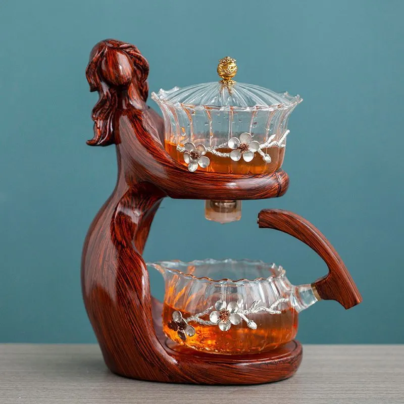 Maid semi-automatic glass tea set with heat-resistant borosilicate glass teapot, stainless steel filters, and Chinese style frame on a tea tray