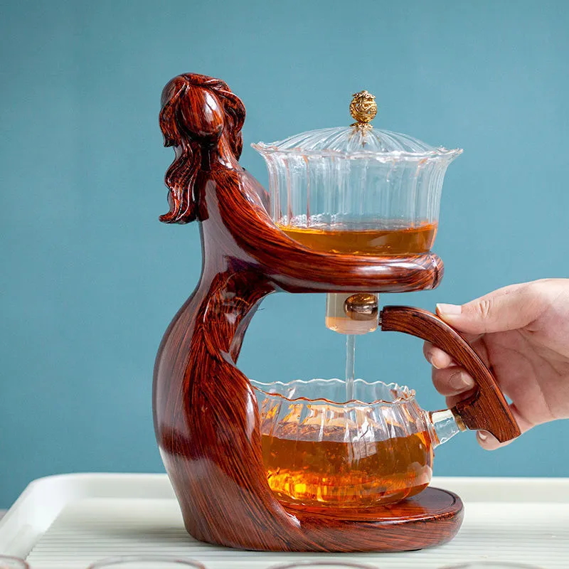 Maid semi-automatic glass tea set with heat-resistant borosilicate glass teapot, stainless steel filters, and Chinese style frame on a tea tray