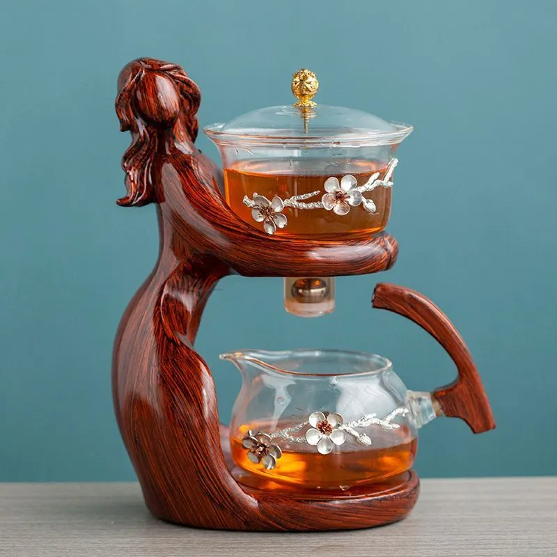 Maid semi-automatic glass tea set with heat-resistant borosilicate glass teapot, stainless steel filters, and Chinese style frame on a tea tray