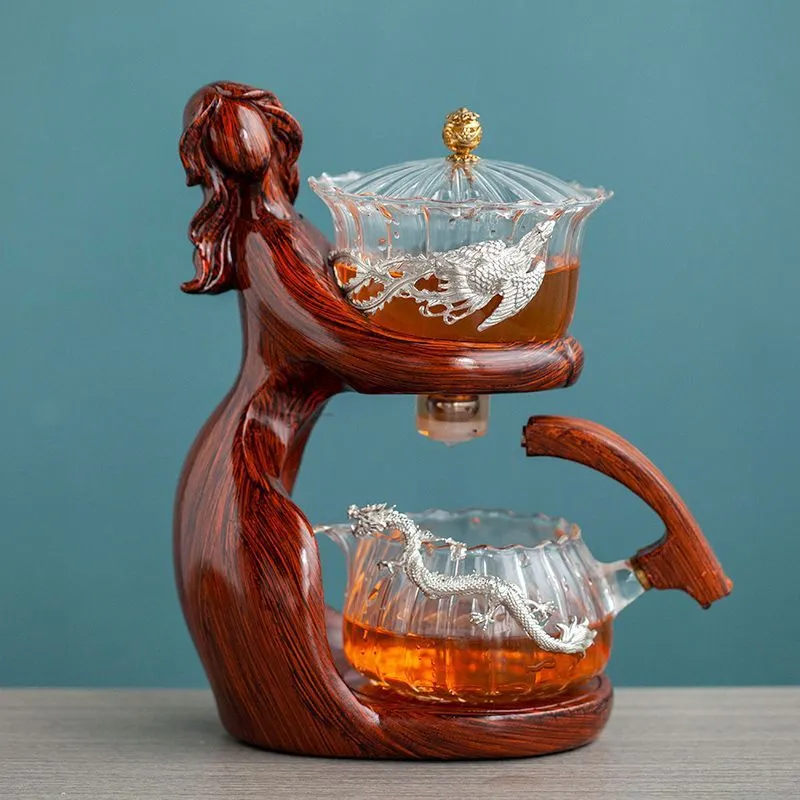 Maid semi-automatic glass tea set with heat-resistant borosilicate glass teapot, stainless steel filters, and Chinese style frame on a tea tray