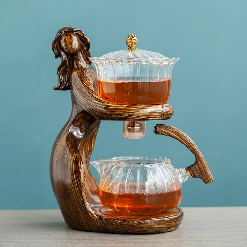 Maid semi-automatic glass tea set with heat-resistant borosilicate glass teapot, stainless steel filters, and Chinese style frame on a tea tray