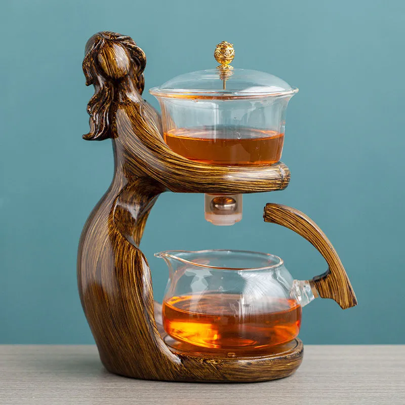 Maid semi-automatic glass tea set with heat-resistant borosilicate glass teapot, stainless steel filters, and Chinese style frame on a tea tray