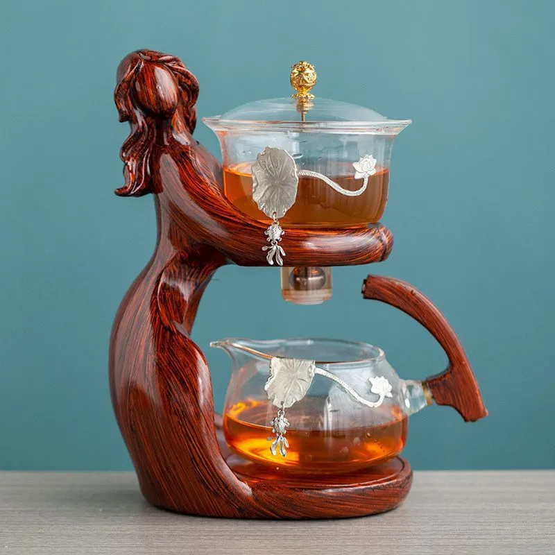Maid semi-automatic glass tea set with heat-resistant borosilicate glass teapot, stainless steel filters, and Chinese style frame on a tea tray