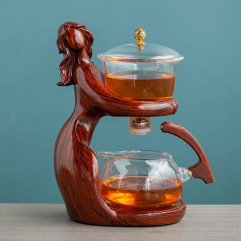 Maid semi-automatic glass tea set with heat-resistant borosilicate glass teapot, stainless steel filters, and Chinese style frame on a tea tray