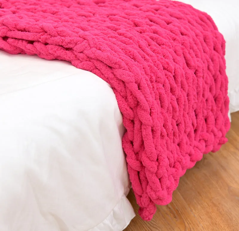 Handmade coarse yarn knitted chenille blanket with thick yarn, cable stitching, beige colour, folded decoratively