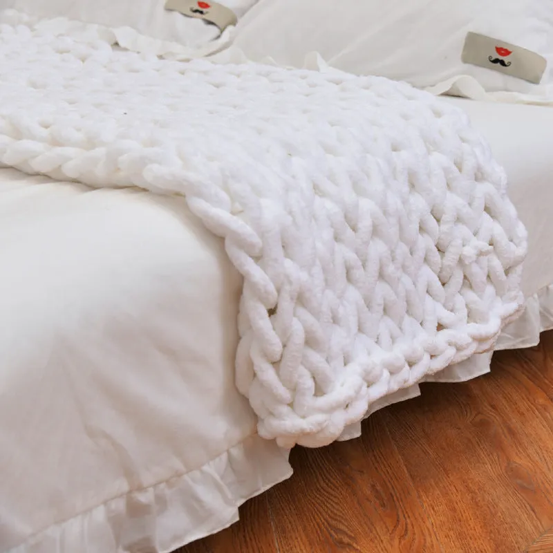 Handmade coarse yarn knitted chenille blanket with thick yarn, cable stitching, beige colour, folded decoratively