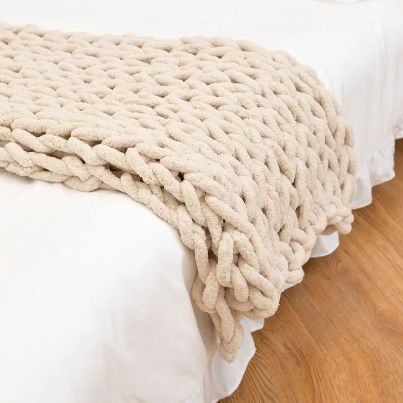 Handmade coarse yarn knitted chenille blanket with thick yarn, cable stitching, beige colour, folded decoratively