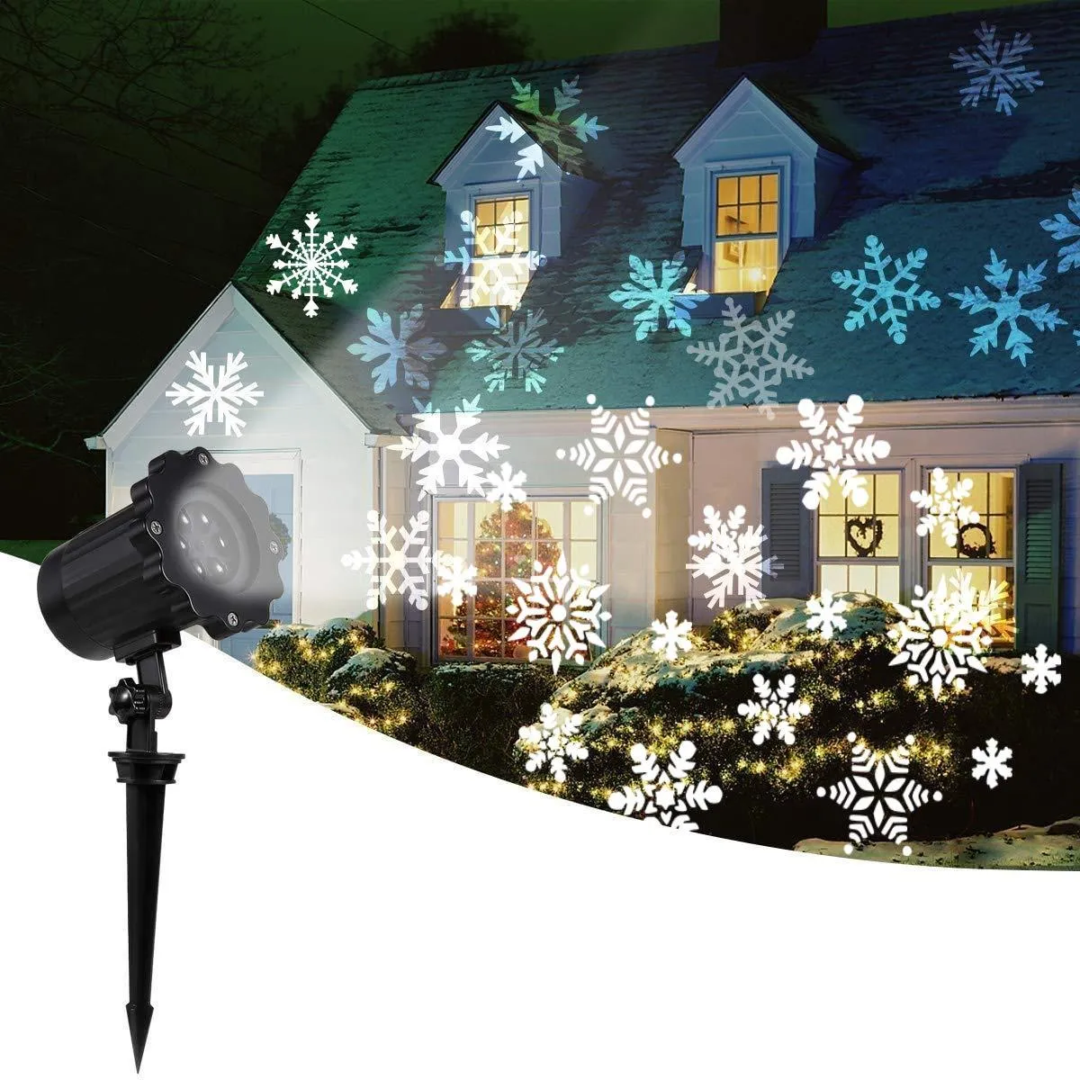 LED Christmas snowflake laser light projector IP65 waterproof with white snowflakes projecting onto a garden wall at night