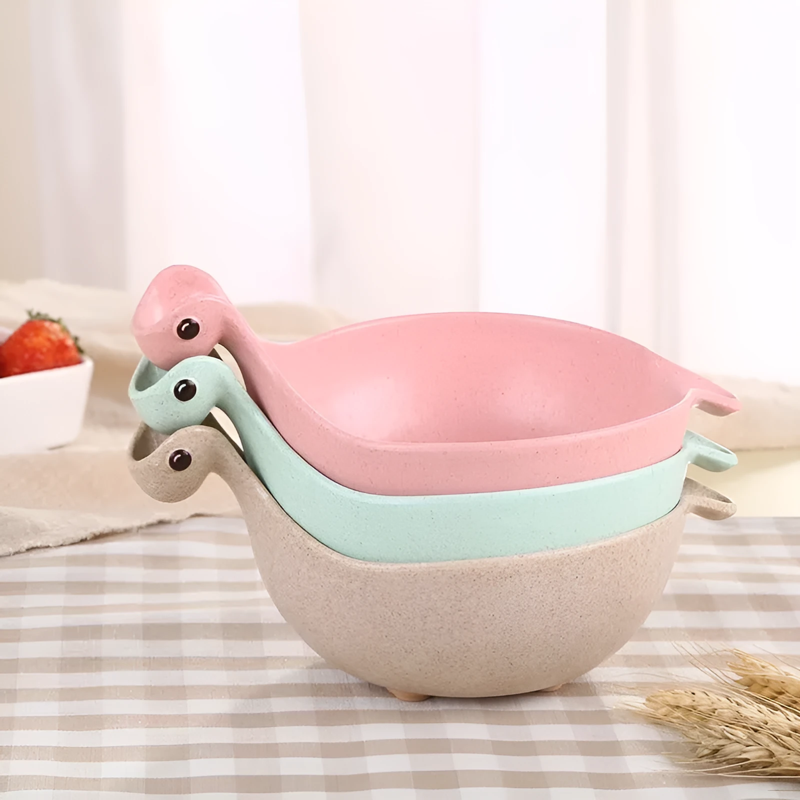 Cute tiny dinosaur bowl made of natural wheat straw fibre in pink, green, and beige colours, lightweight non-slip unbreakable design