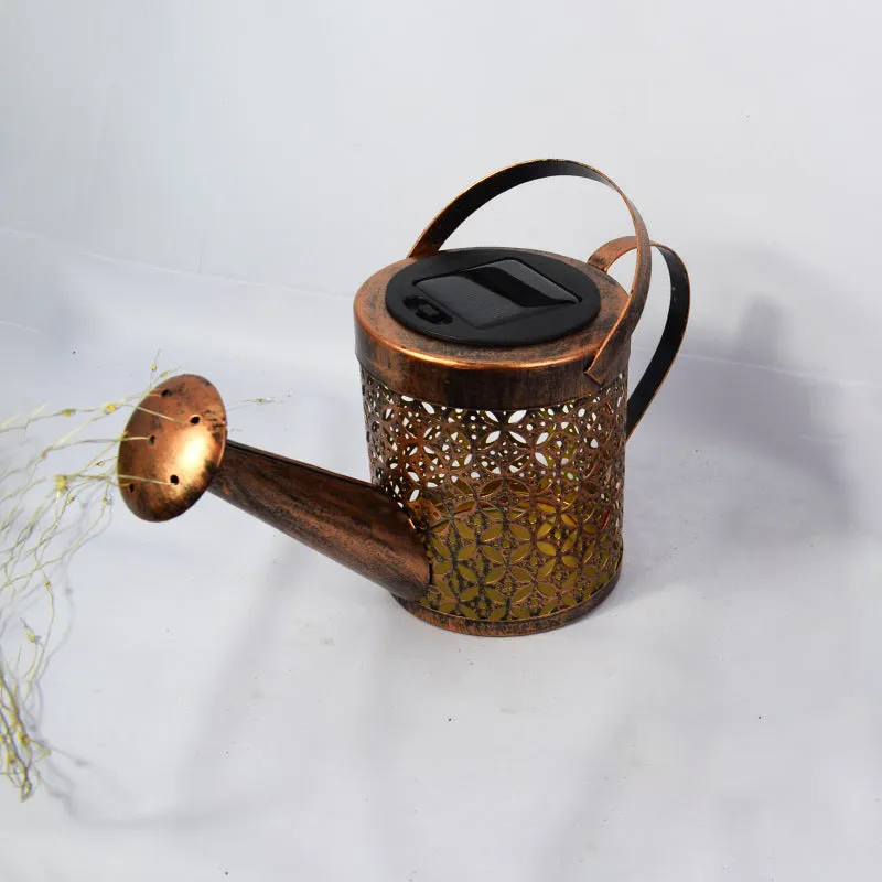 Solar watering can garden lamp with hollow-out iron shower body and 36 warm white LED lights on copper wire, installed in grass