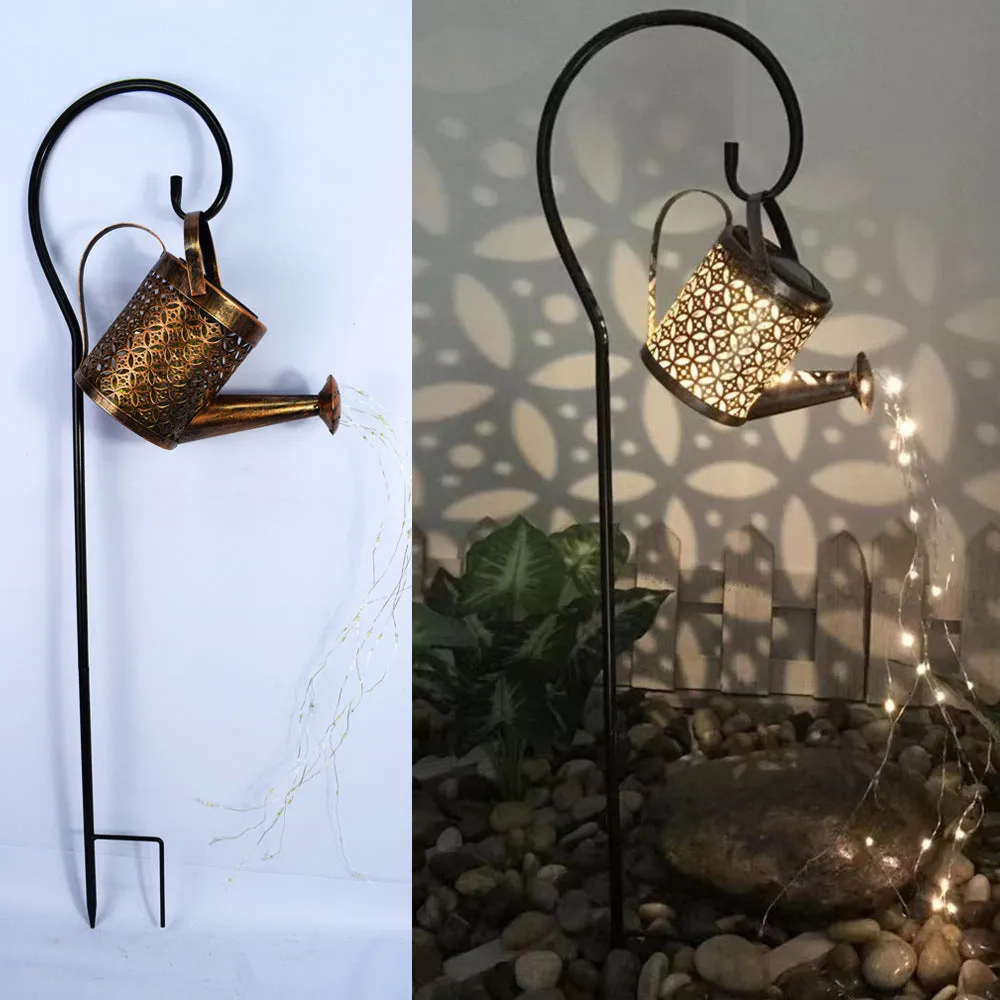 Solar watering can garden lamp with hollow-out iron shower body and 36 warm white LED lights on copper wire, installed in grass