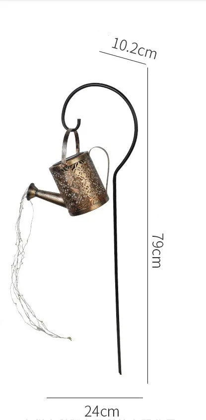 Solar watering can garden lamp with hollow-out iron shower body and 36 warm white LED lights on copper wire, installed in grass