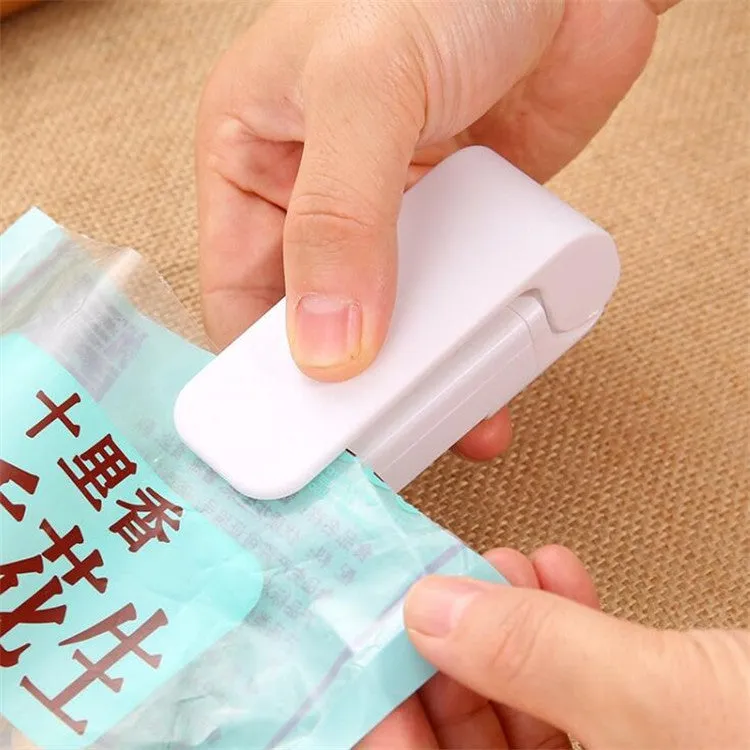 Pink household food clip portable mini plastic bag heat sealer on white background