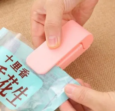 Pink household food clip portable mini plastic bag heat sealer on white background