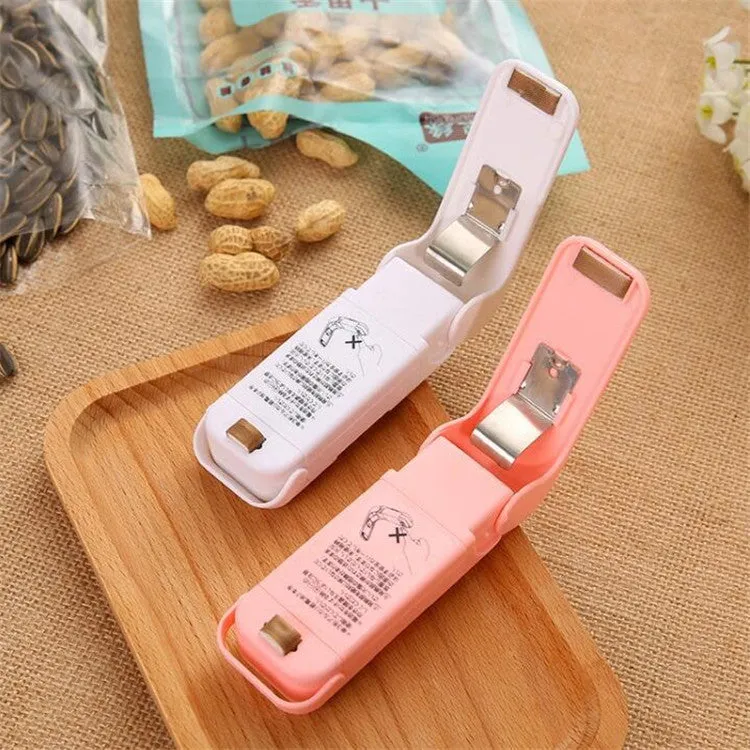 Pink household food clip portable mini plastic bag heat sealer on white background