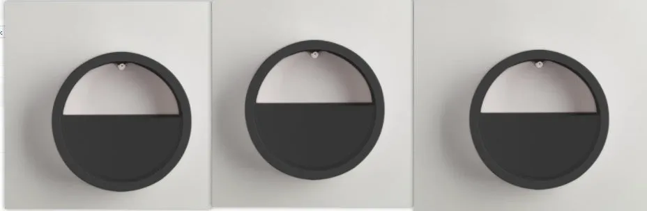 Round iron wall vase in black hanging on a wall with a succulent plant inside