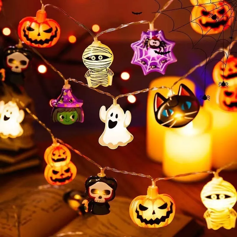 PVC Halloween lighting chain with pumpkin, ghost and bat shapes in warm white LED glow