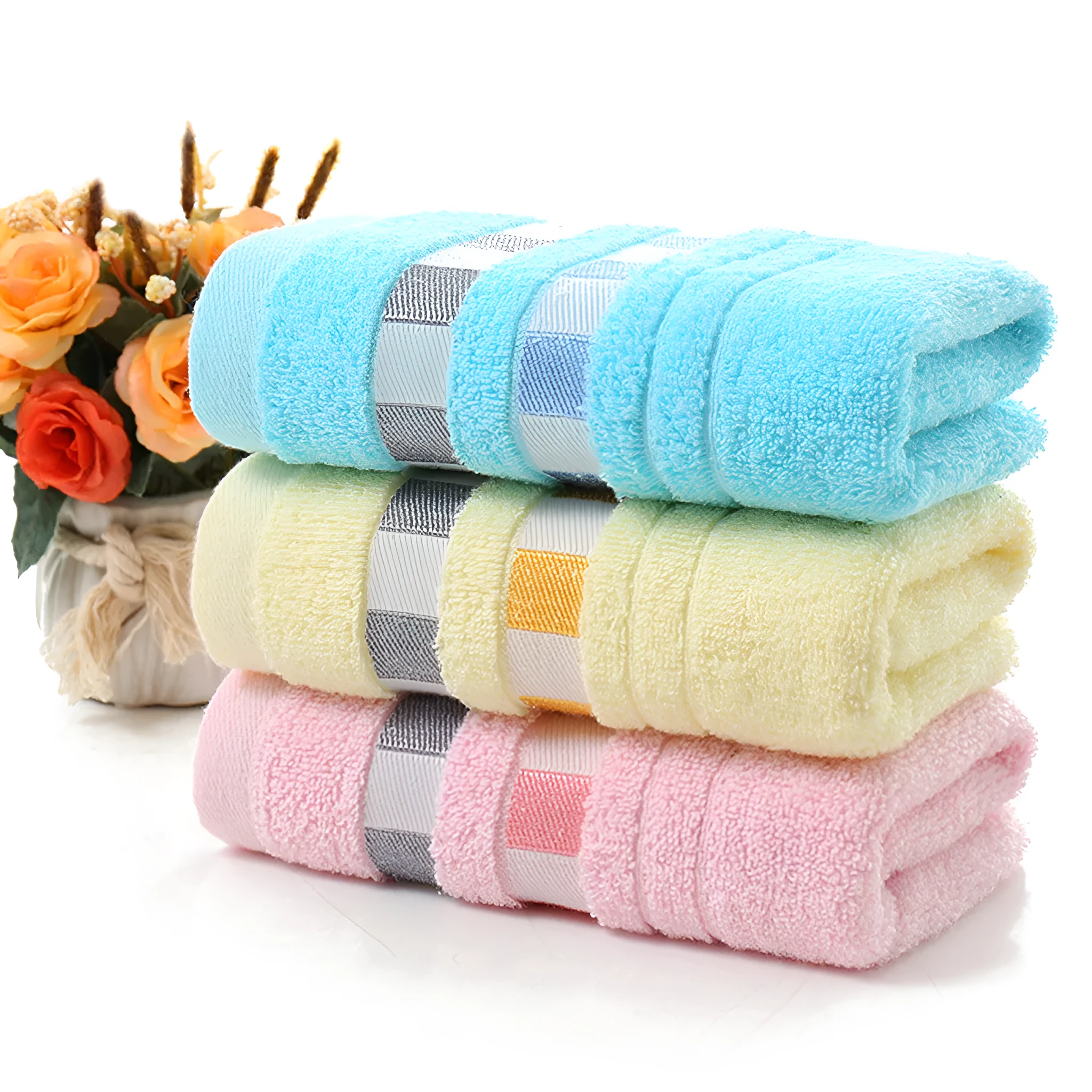Cotton face towel 73x33cm in blue pink yellow patterns on hanger