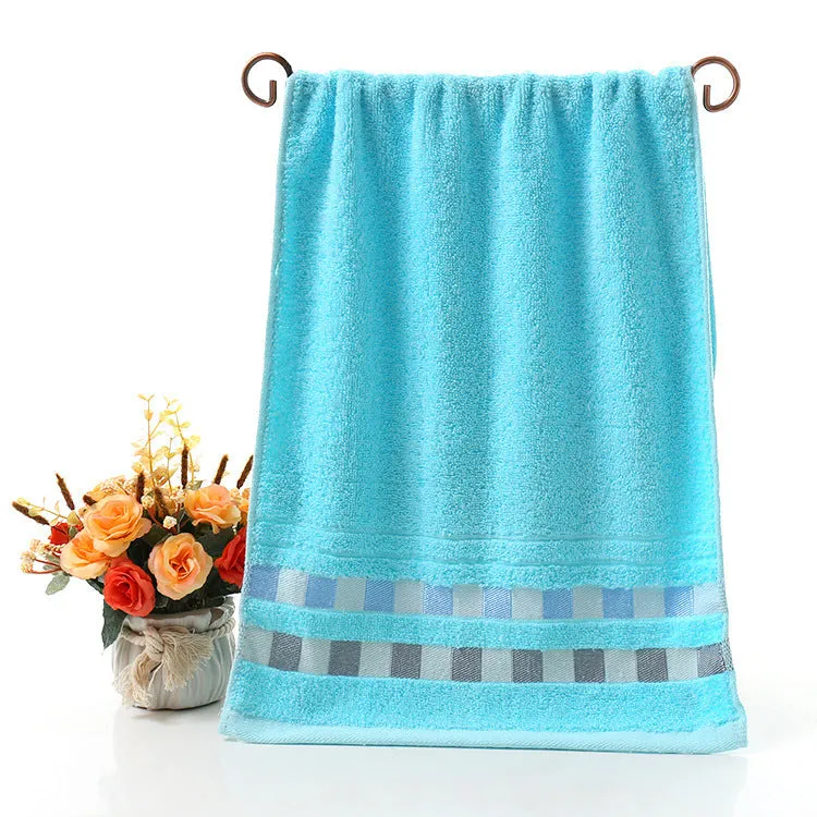Cotton face towel 73x33cm in blue pink yellow patterns on hanger