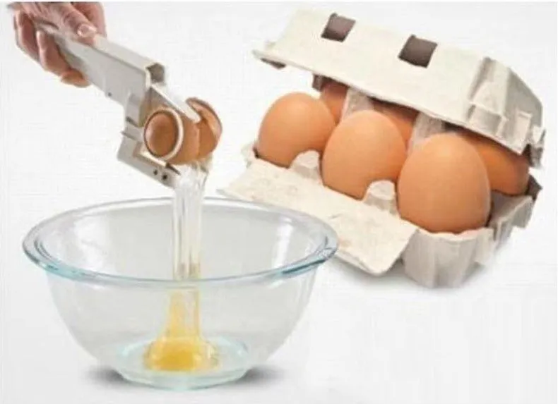White handheld egg shell cracker with curved silicone grip and metal mechanism on a kitchen counter