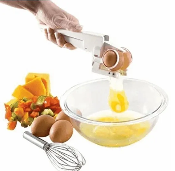 White handheld egg shell cracker with curved silicone grip and metal mechanism on a kitchen counter