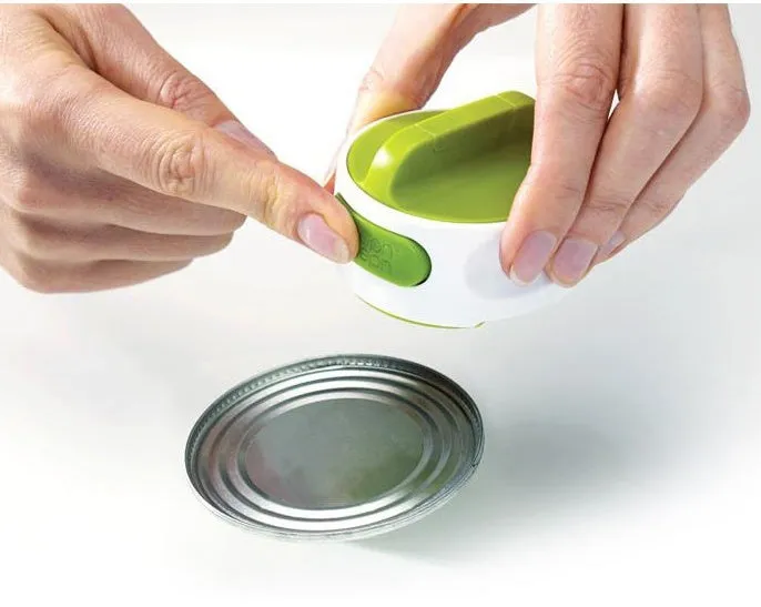 Compact manual can opener with stainless steel blade and ABS plastic body on a kitchen counter