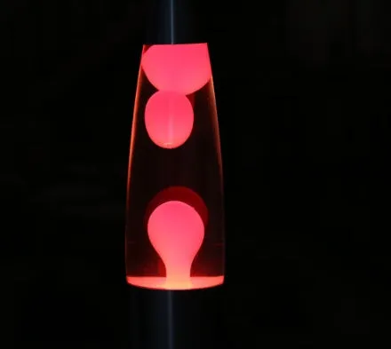 Blue lava lamp with metal base and glass bottle showing wax rising in heated liquid