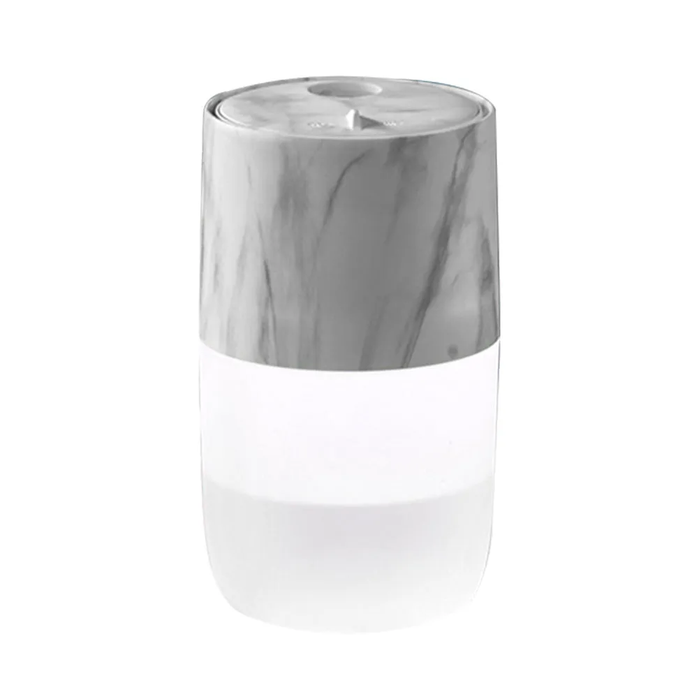 Mini USB jellyfish air humidifier in white with hollow ABS shell on desk
