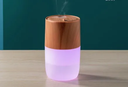 Mini USB jellyfish air humidifier in white with hollow ABS shell on desk