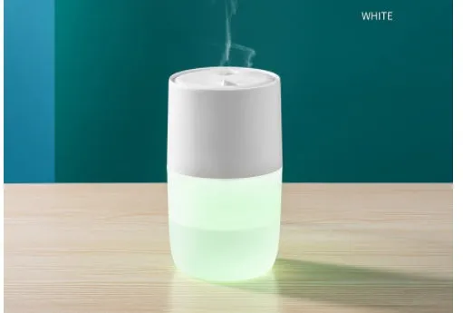 Mini USB jellyfish air humidifier in white with hollow ABS shell on desk