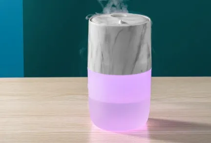 Mini USB jellyfish air humidifier in white with hollow ABS shell on desk