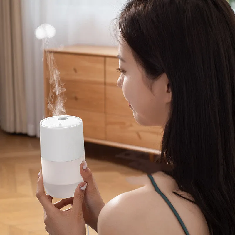 Mini USB jellyfish air humidifier in white with hollow ABS shell on desk
