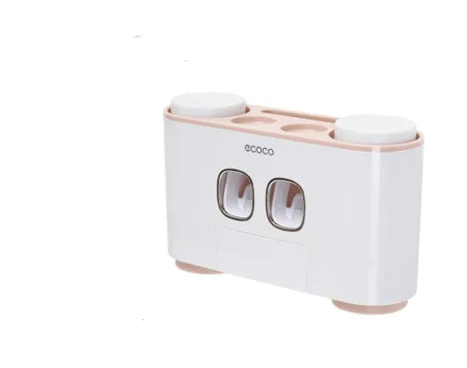 Plastic wall-mounted toothbrush holder with four magnetic cups in pink, blue, and green for family bathroom