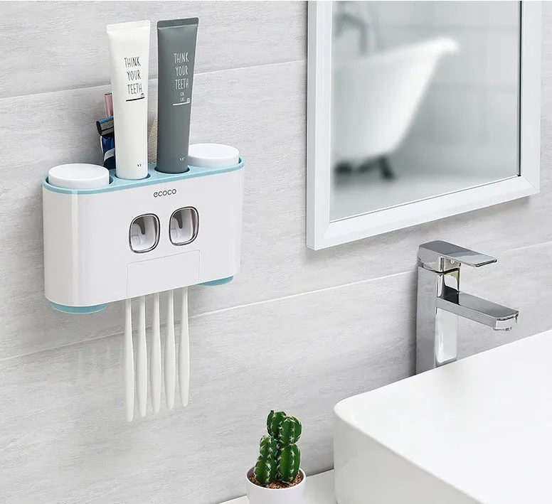 Plastic wall-mounted toothbrush holder with four magnetic cups in pink, blue, and green for family bathroom