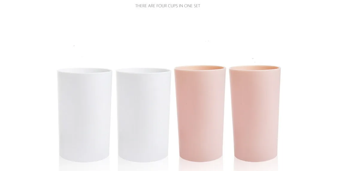 Plastic wall-mounted toothbrush holder with four magnetic cups in pink, blue, and green for family bathroom