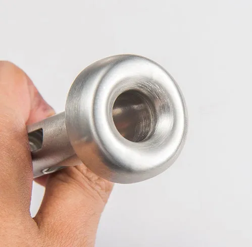 Silver stainless steel wine cooling rod with pourer next to a red wine bottle