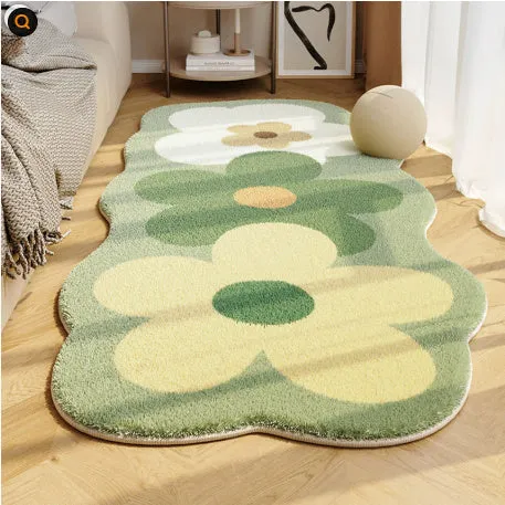 Flower-shaped blanket with printed cartoon floral design in green and white colours, laid flat.
