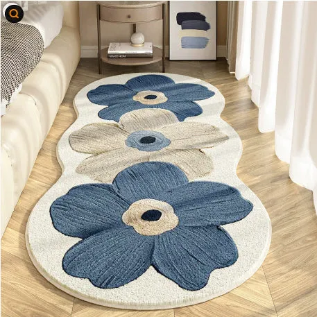 Flower-shaped blanket with printed cartoon floral design in green and white colours, laid flat.