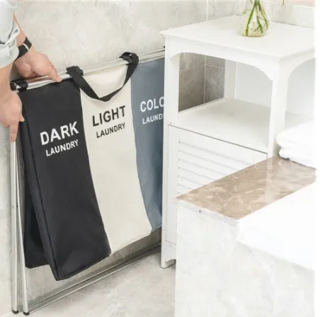 Foldable three-compartment laundry basket in Oxford cloth with aluminium frame, collapsed for space-saving storage