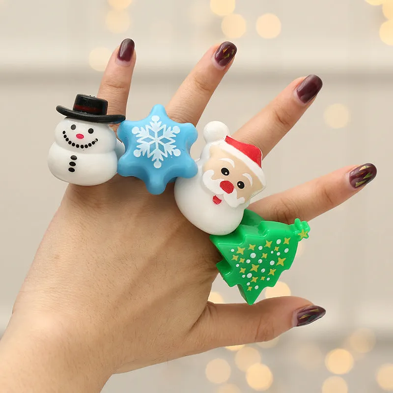 Set of four Christmas party finger lights with designs of small tree, elderly figure, snowflake, and snowman on display