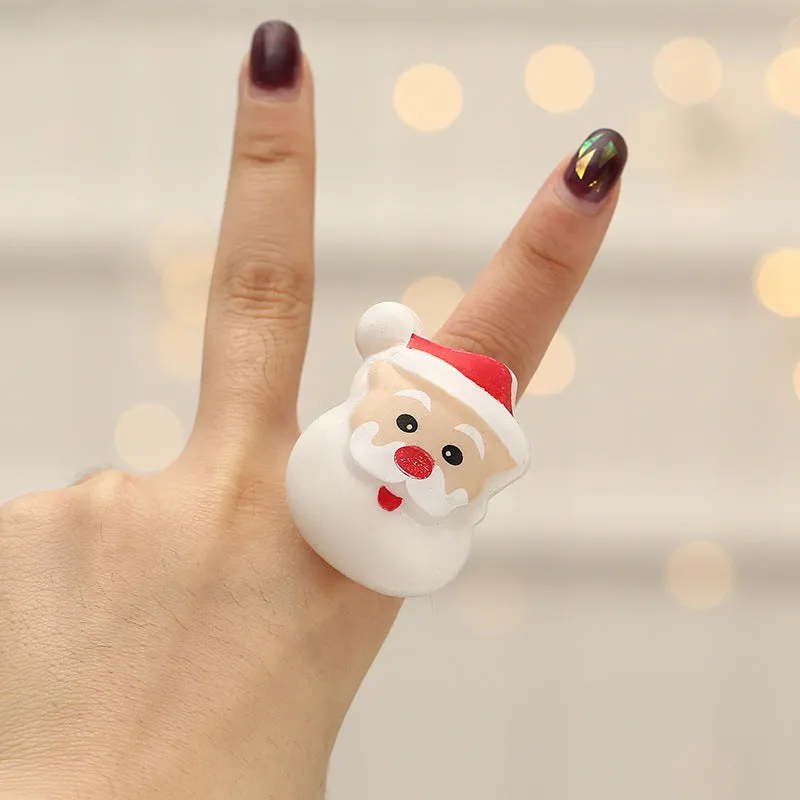 Set of four Christmas party finger lights with designs of small tree, elderly figure, snowflake, and snowman on display